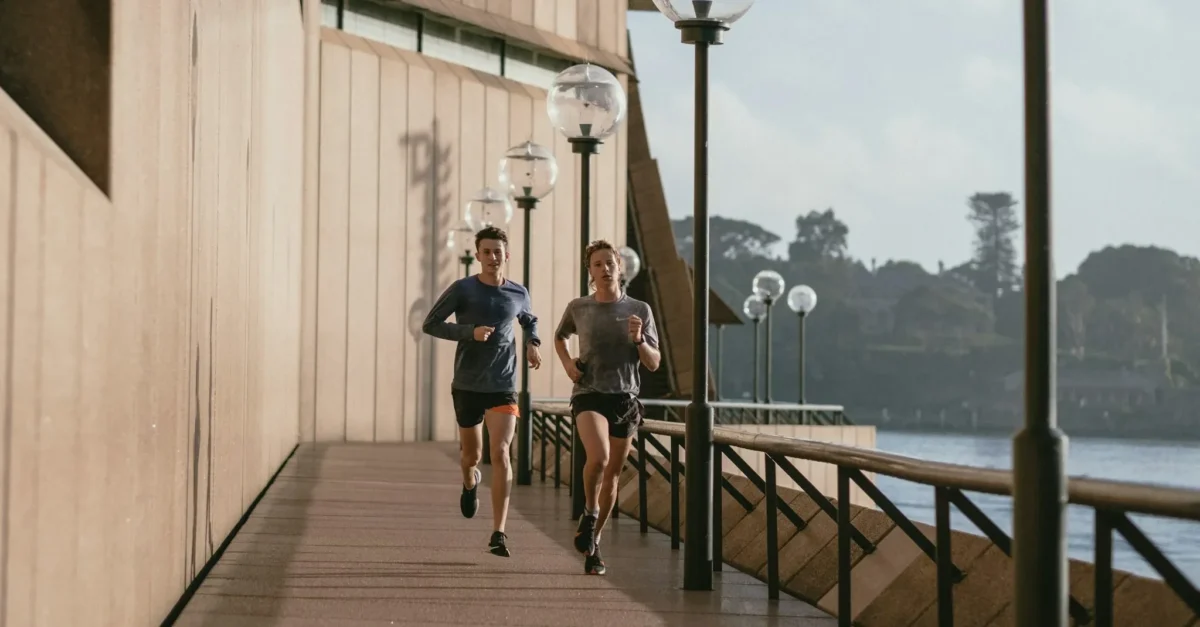A couple jogging beside the canal in the morning.