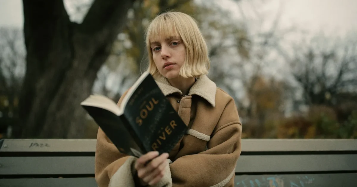 A girl reading a book and having a blunt bob haircut