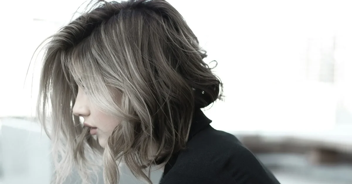 A sitting girl having a shaggy bob haircut