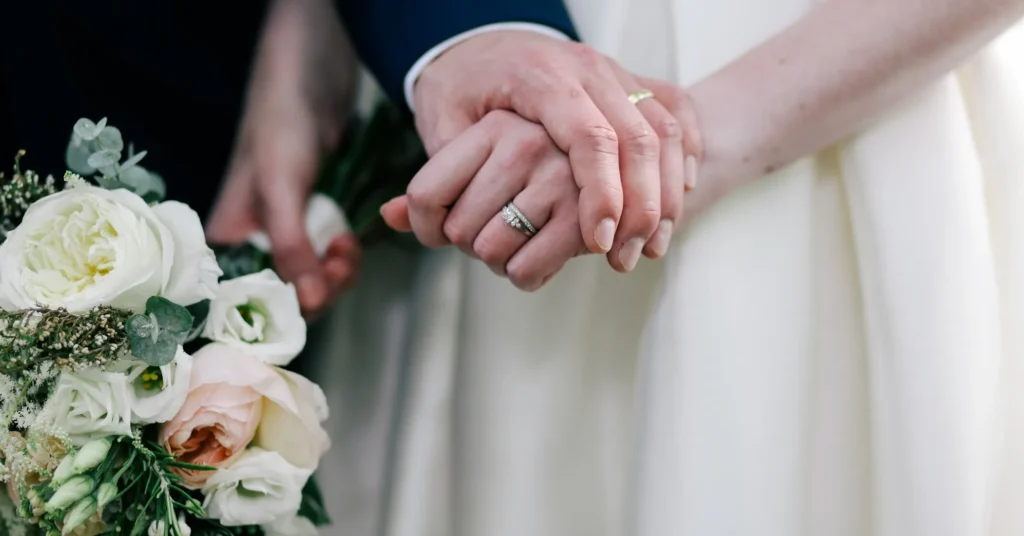 A couple holding each other's hands.