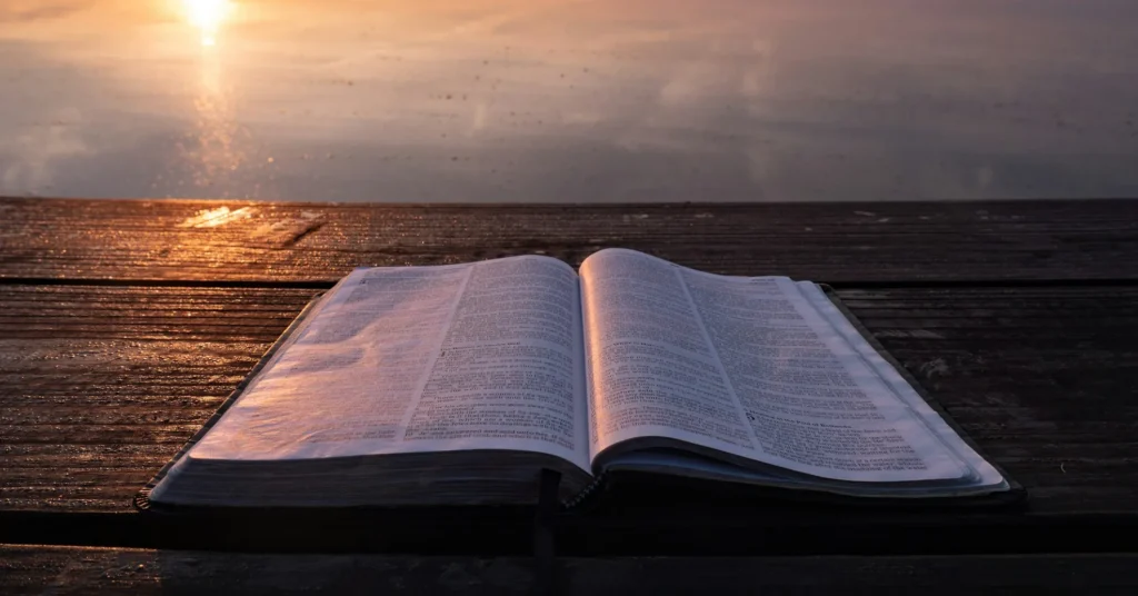 An open Bible on a table with sunshine placing on it, symbolizing Biblical signs God wants you to end your marriage.