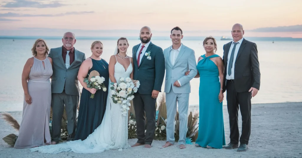 Family is standing beside the couple on their marriage cermony.