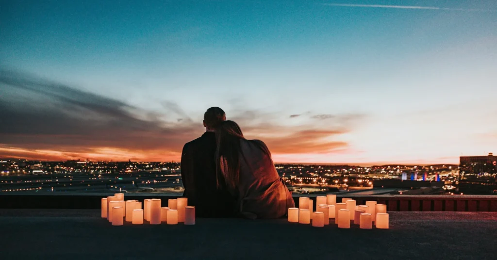 A man and woman joyfully sitting together, embodying the essence of making time for your partner.