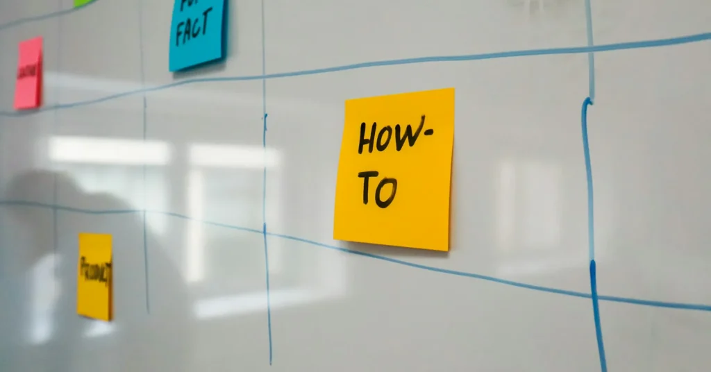 A sticky note is attached to tiled wall on which How to is written.