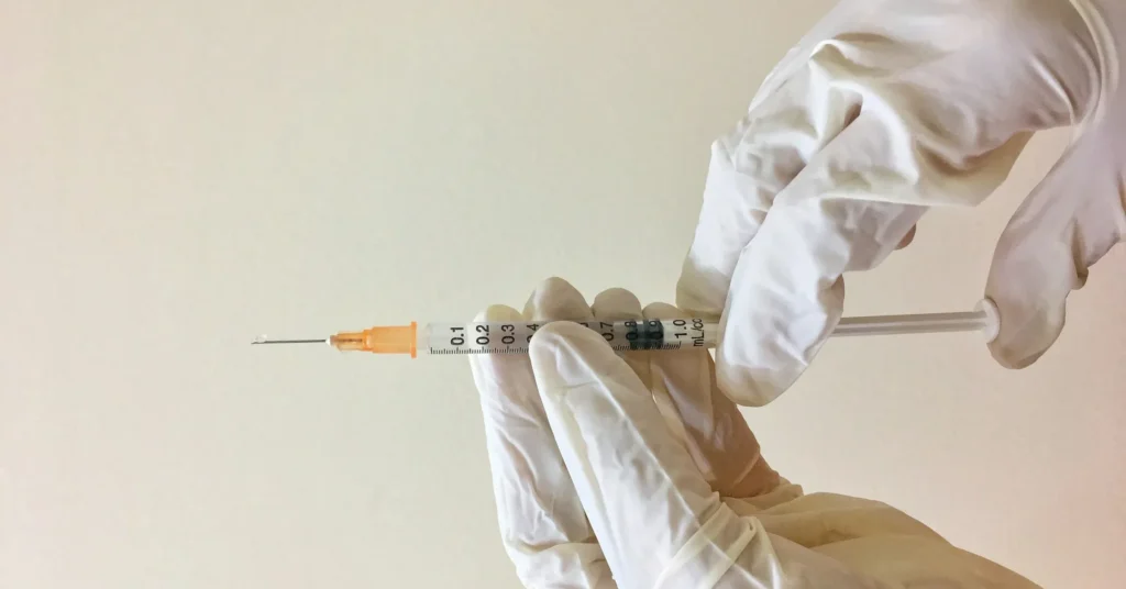 A doctor holding the injections for removing the buccal fat.