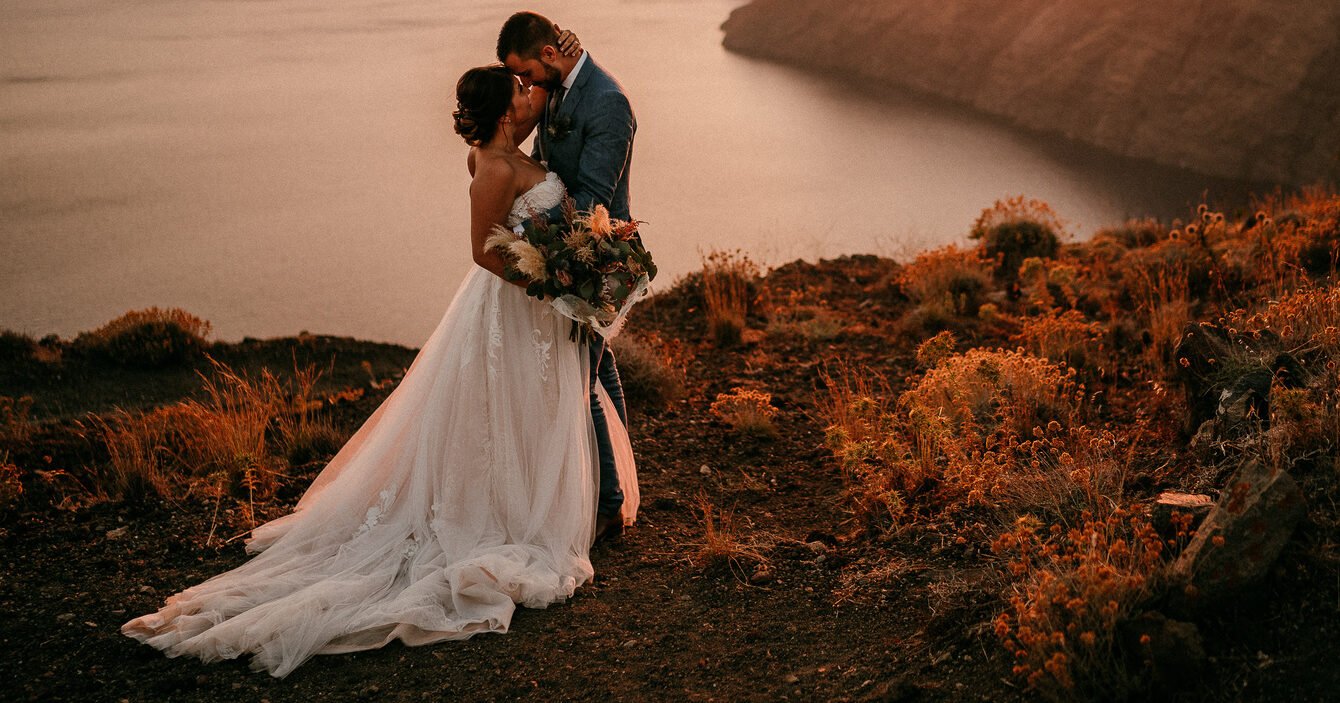 A Santorini wedding photographer captures the essence of love, exploring if eloping and marriage are synonymous.
