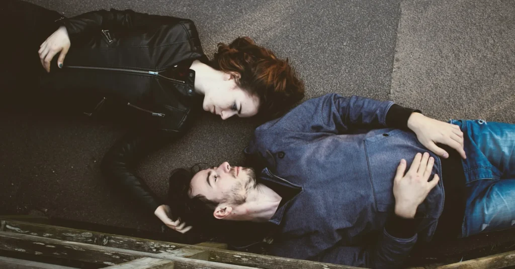 A loyal couple lying on the floor and seeing each other with love