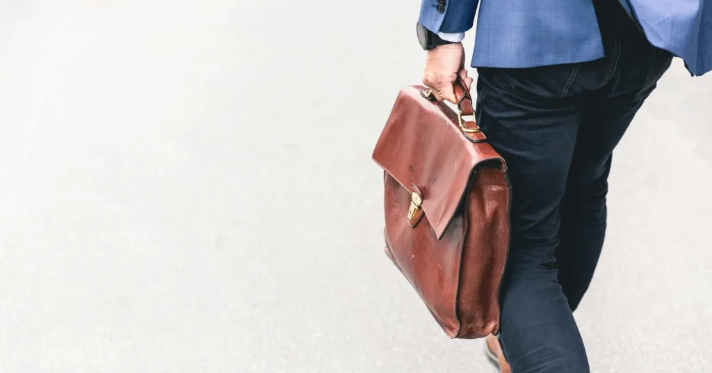 A working man holding a bag.