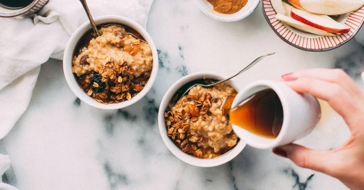 A fat free bosco syrup is pouring on the oats meal.